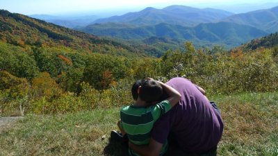 Ray and Nicholas Hemachandra sitting by the Blue Ridge Parkway in North Carolina (photo by Kristi Pfeiffer)