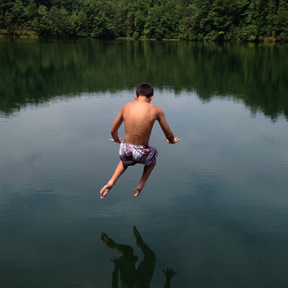 Nicholas leaps into Fawn Lake in DuPont State Forest, North Carolina.