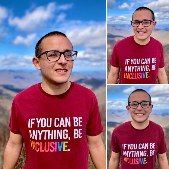 Nicholas Hemachandra on a mountaintop wearing a shirt that says, "If you can be anything, be inclusive."