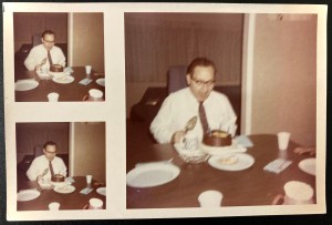 A 1960s photo sheet of three identical images, two on the left side next to a larger one, of a man wearing glasses, a white dress shirt, and a tie sitting at a dining room table, thrilling over his birthday cake, with a cake cutter poised to slice into it. The man pictured is John Harvey, the poet's late uncle.